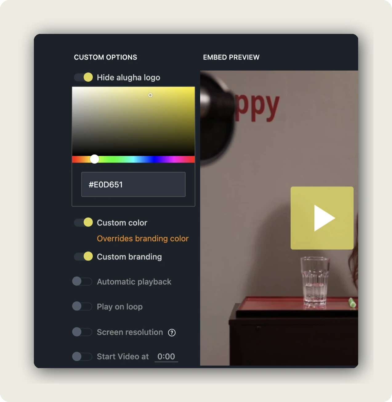 The alugha embed's custom colour picker set to a pale yellow, next to a preview whose white play icon sits on that yellow