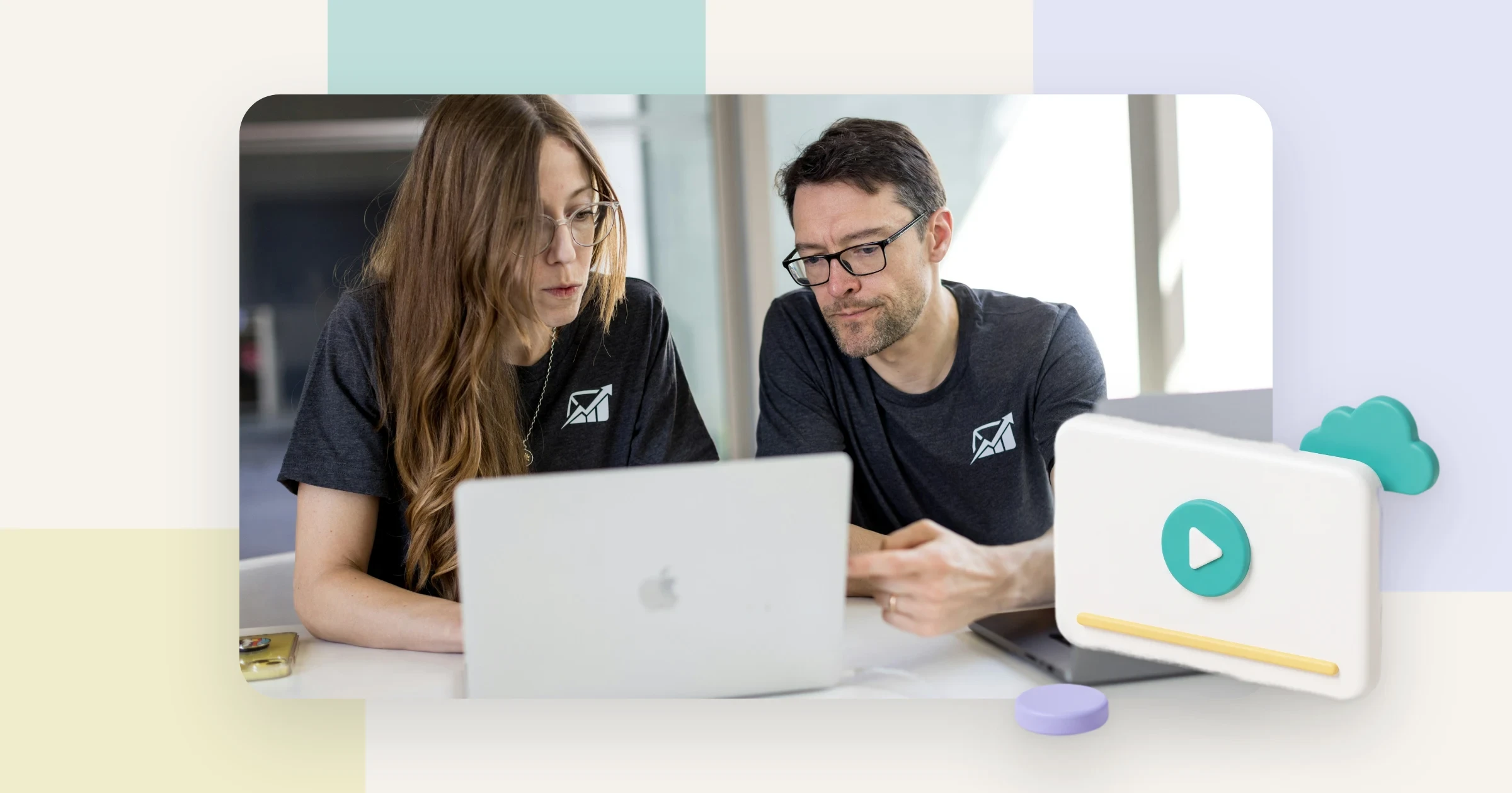Two colleagues looking at a laptop together, with a player card and cloud, for choosing a YouTube alternative