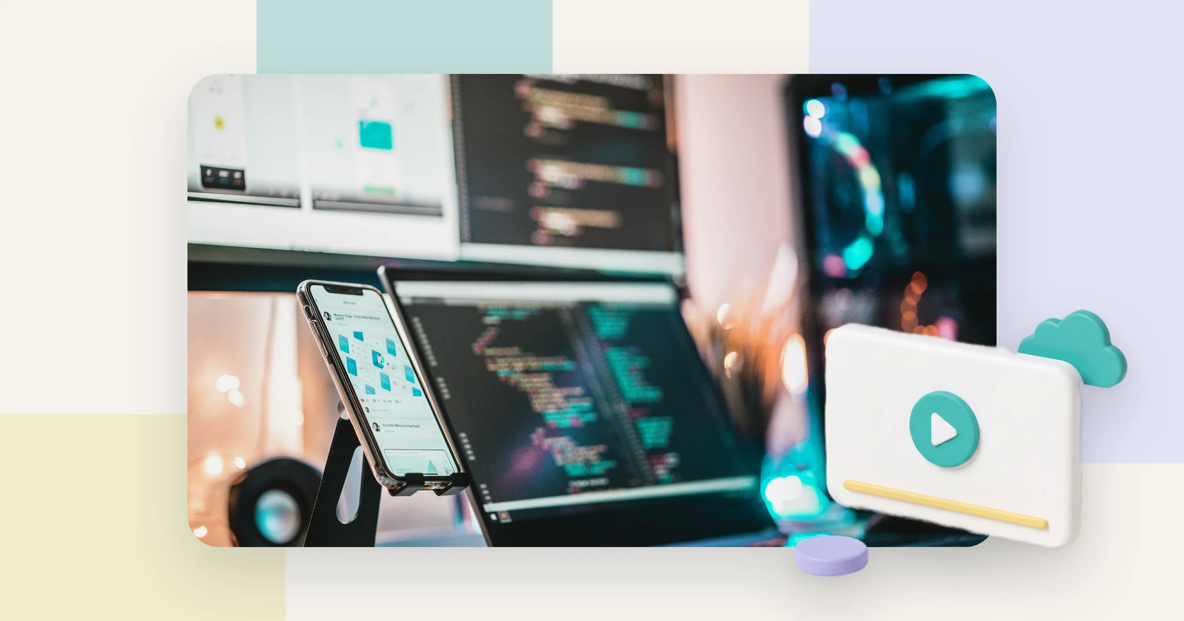 A developer desk with code on two screens and a phone, where you embed video on a website