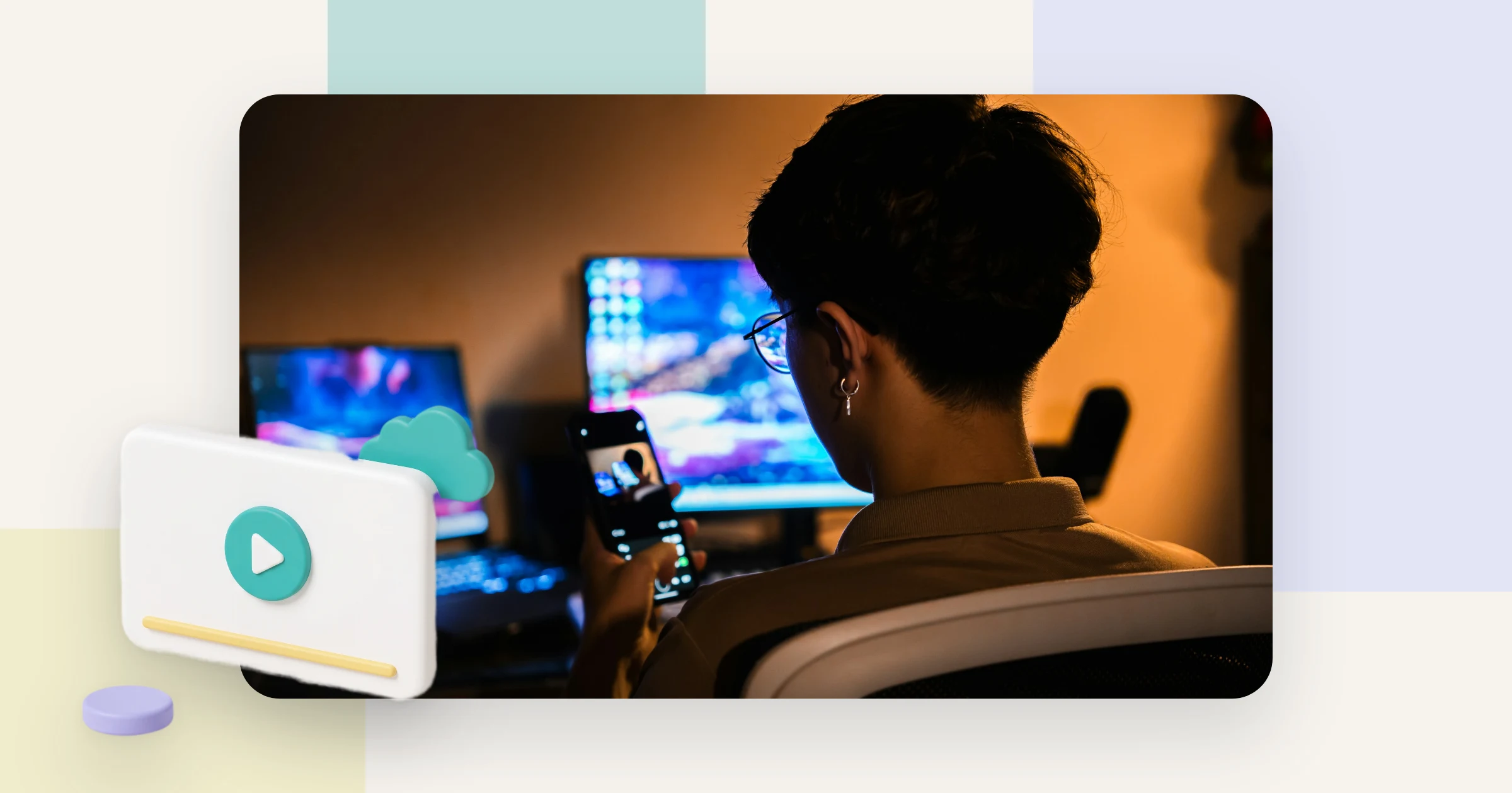 A person holds a phone in front of several monitors in warm light, the setting where video DRM protects paid content