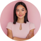 Smiling woman in pink shirt with arms crossed