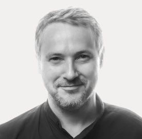 Portrait of a smiling man with light background.